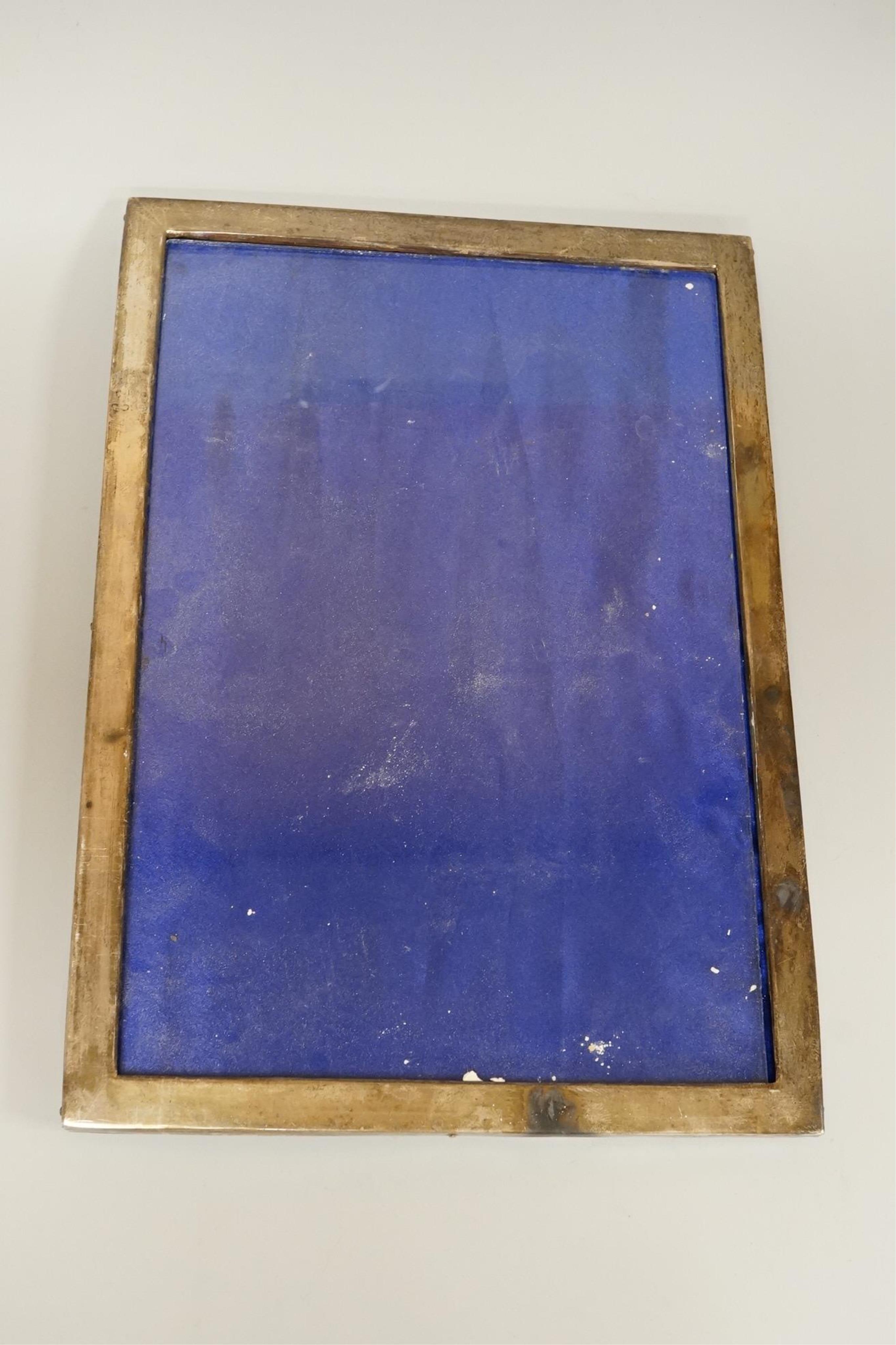 Four assorted early 20th century silver mounted photograph frames, the largest by Sanders & Mackenzie, Birmingham, 1915, 30.3cm by 21.6cm, together with two small Spanish white metal mounted photograph frames.